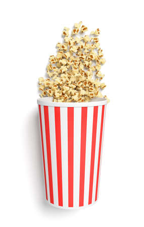 3d rendering of a round striped popcorn bucket lying on its side with popcorn spilling out of it in top view.の写真素材