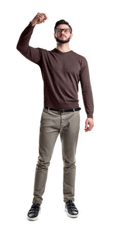 A bearded man in smart casual clothes looks side up with his arms folded on his chest.の写真素材