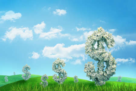 3d rendering of endless green field full of large dollar signs made of banknotes standing under blue sky.の写真素材
