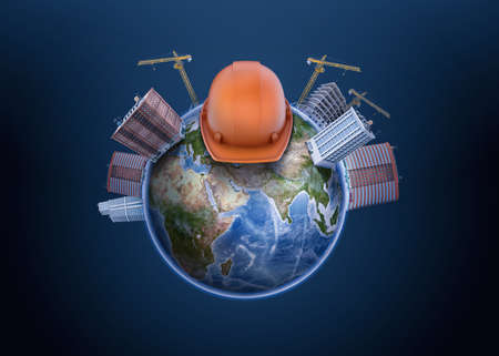 3d rendering of Earth globe with high apartment buildings constructed on it with cranes, and a hard hat in the middle.の写真素材