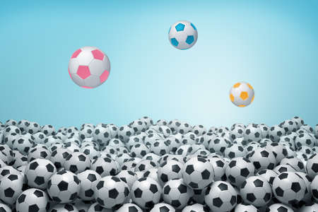 3d rendering of sea of identical black and white soccer balls with three balls of bright colors flying above it.の写真素材