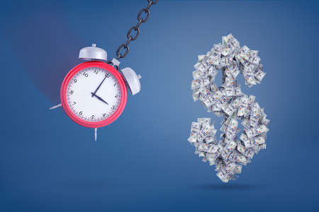 3d rendering of red retro alarm clock swings like a wrecking ball ready to hit a dollar sign made of many bills.の写真素材