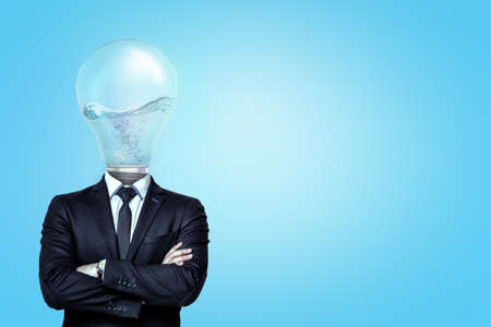 Businessman with a light bulb with liquid instead of head on blue backgroundの写真素材