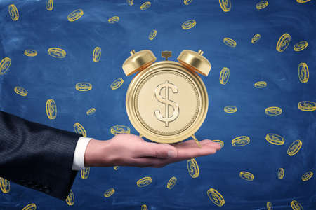 Mans hand with palm facing up to hold an alarm clock with a stylized dollar coin instead of clock...