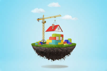 3d rendering of a building crane putting a roof on lego house on a piece of land in the air on blue...