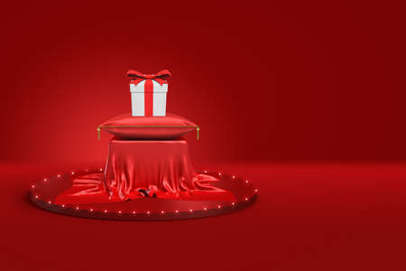 3d rendering of white gift box with red ribbon on red cushion and pedestal covered with red cloth on red backgroundの写真素材