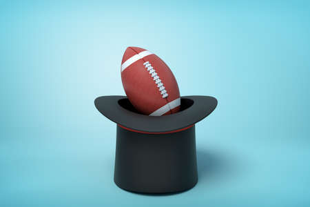 3d rendering of black tophat upside down with brown gridiron football inside on light blue background.の写真素材