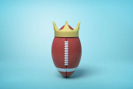 3d rendering of brown ball for American football standing upright and wearing golden crown on light blue background.の写真素材