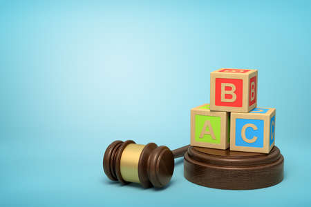 3d rendering of colorful alphabet toy blocks on round wooden block and brown wooden gavel on blue backgroundの写真素材