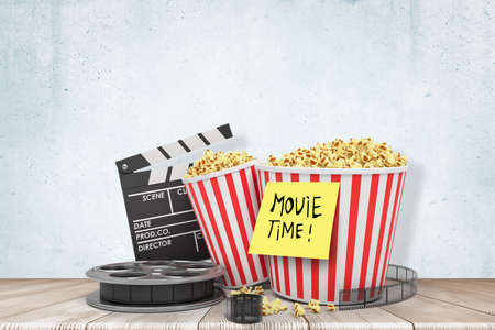3d rendering of film reel, clapperboard and two pop corn buckets, wit note Move Time on one of them.の写真素材