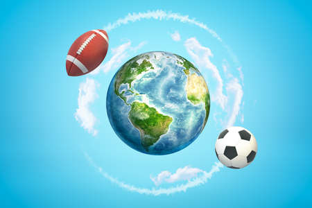 3d rendering of brown american football ball and soccer ball flying around earth globe on blue backgroundの写真素材