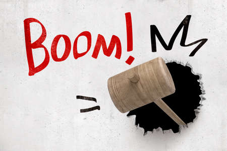 3d rendering of wooden hammer breaking white wall with red Boom sign on white backgroundの写真素材