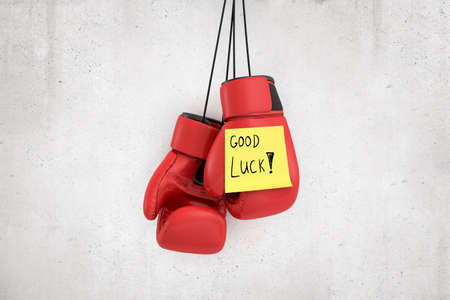 3d rendering of red boxing gloves with yellow Good luck note on white wall backgroundの写真素材