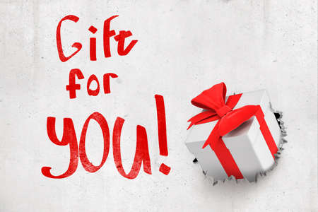3d rendering of concrete wall with title Gift for you and white gift box that has broken through from behind the wall.の写真素材