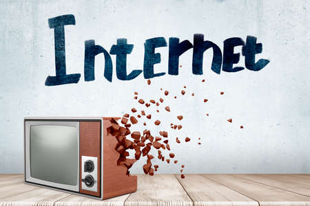 3d rendering of old TV set which starts to break into pieces near wall with title Internet.の写真素材