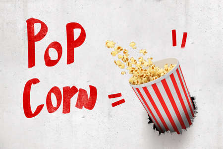 3d rendering of concrete wall with title Pop Corn and pop corn bucket that has broken hole in the wall.の写真素材