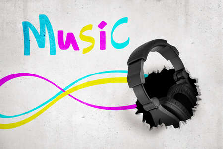 3d rendering of black headphones breaking white wall with colorful MUSIC signの写真素材