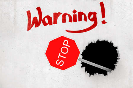 3d rendering of red STOP traffic sign breaking white wall with Warning sign on white backgroundの写真素材