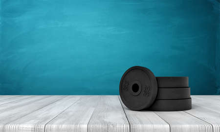 3d rendering of black weight plates on white wooden floor and dark turquoise backgroundの写真素材