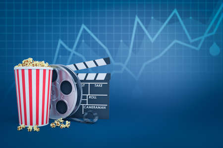3d rendering of popcorn bucket, film reel and clapperboard against blue background with line graphs and some copy space.の写真素材