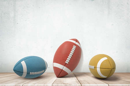 3d rendering of three american football balls on white wooden floor background. Games and sports. Outdoor activities. Sporting goods.の写真素材