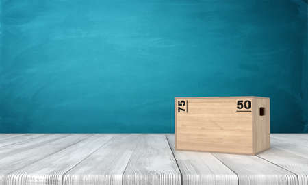 3d rendering of light brown sport box with black size markers, standing on wooden floor in front of blue wall.の写真素材