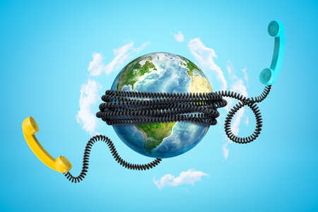 3d rendering of Earth with phone wires bound around it and two phone receivers floating beside in bright blue sky. Global communication. Staying in touch.の写真素材