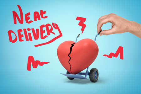 Hand holding hand truck with red broken heart and Neat delivery sign on blue backgroundの写真素材