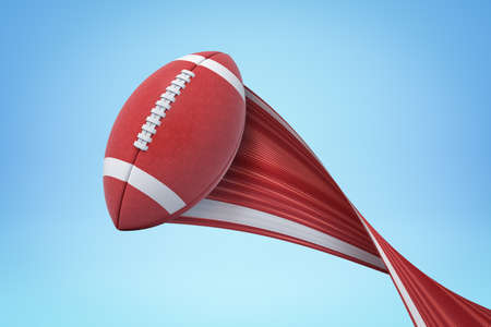 3d rendering of american football ball with trail on blue backgroundの写真素材