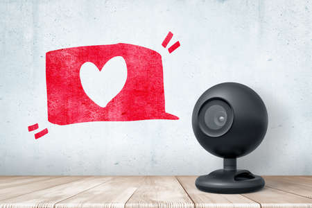 3d rendering of black web camera standing on wooden desk near grungy gray wall with hand-drawn red...
