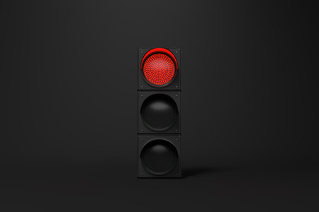 Single red traffic light glowing brightlyの写真素材