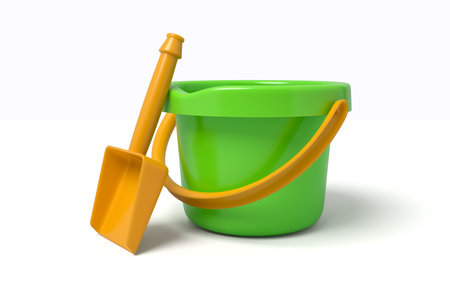 Green plastic bucket with gold shovelの写真素材