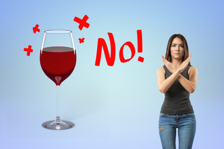 Woman rejecting wine with a clear no signの写真素材