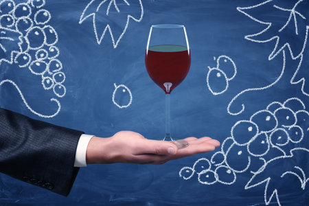 Hand offering wine glass drawing on chalkboardの写真素材