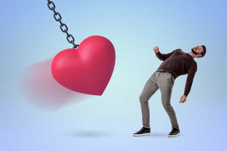Person chained to a giant floating heart with blurred faceの写真素材