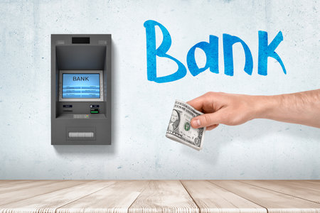 Hand withdrawing cash from ATM machine drawingの写真素材