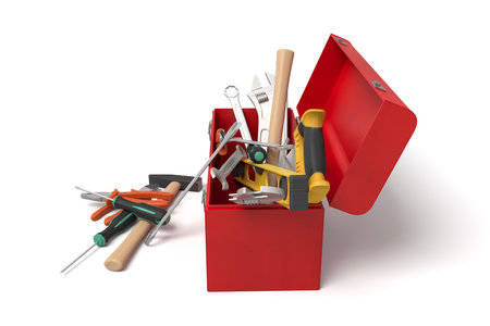 Tilted red toolbox with tools falling outの写真素材