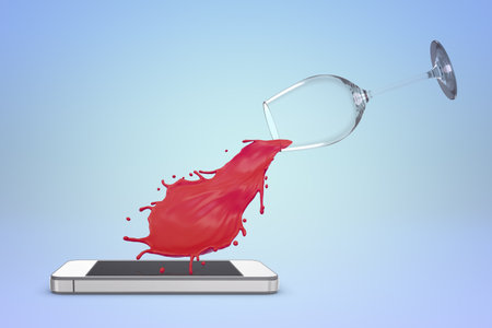 Red wine spill from glass to smartphoneの写真素材