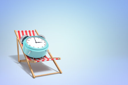 Alarm clock on deck chair isolated on blueの写真素材