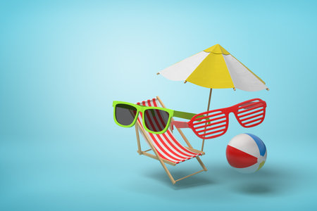 Striped deck chair, sunglasses, beach ballの写真素材