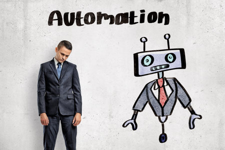 Man contemplating automation with robotの写真素材