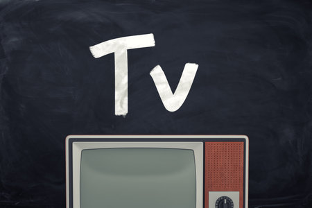 Vintage television set with the word Tv on blackboard
