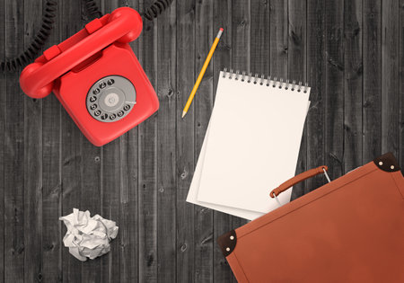 Vintage red phone and office items on deskの写真素材