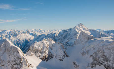 Snow-covered mountain peaks of Engelberg ski resort in Switzerland.の写真素材