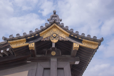 Wooden structures are enhanced with golden crane motifs and metalwork, showcasing symbolic...