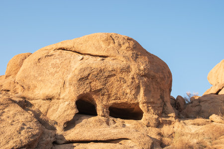 The Namibian desert is home to scattered brown stones and rugged rock formations shaped by natural processes over millennia.の写真素材