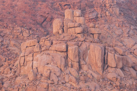 The Namibian desert is home to scattered brown stones and rugged rock formations shaped by natural processes over millennia.の写真素材
