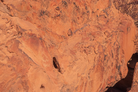 The Namibian desert is home to scattered brown stones and rugged rock formations shaped by natural processes over millennia.の写真素材