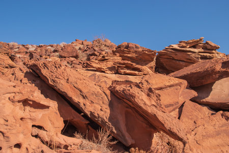 The Namibian desert is home to scattered brown stones and rugged rock formations shaped by natural processes over millennia.の写真素材