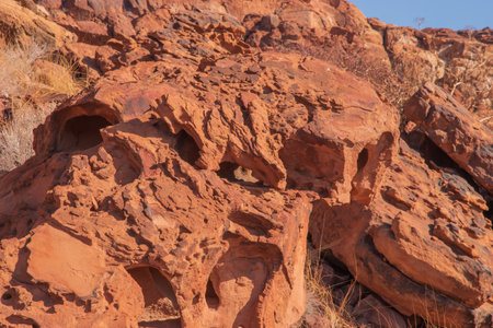 The Namibian desert is home to scattered brown stones and rugged rock formations shaped by natural processes over millennia.の写真素材